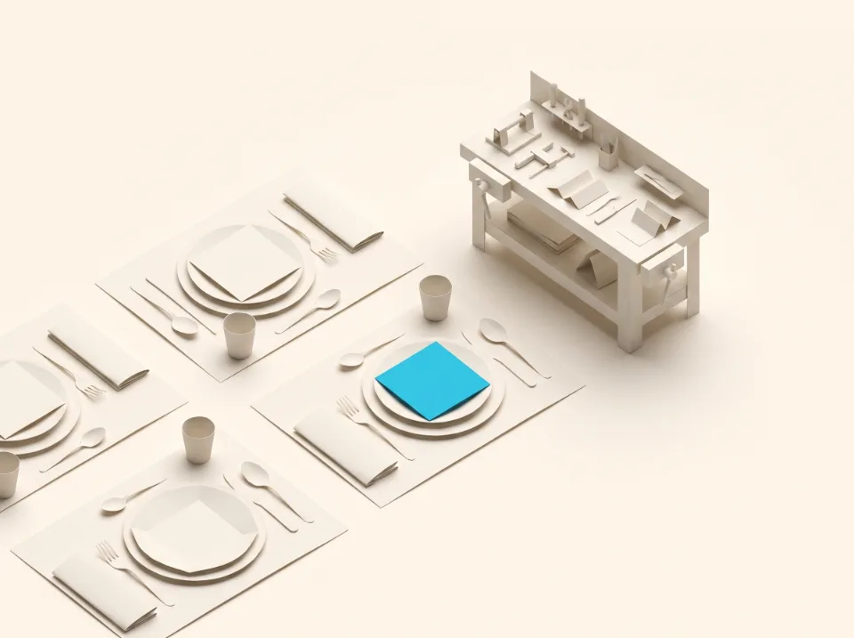 Papier-Illustration: gedeckte Tische aus Faltpapier neben einer kleinen Werkbank – Sinnbild für Gastronomie und Handwerk in Brüggen, ein Gedeck in Cyan