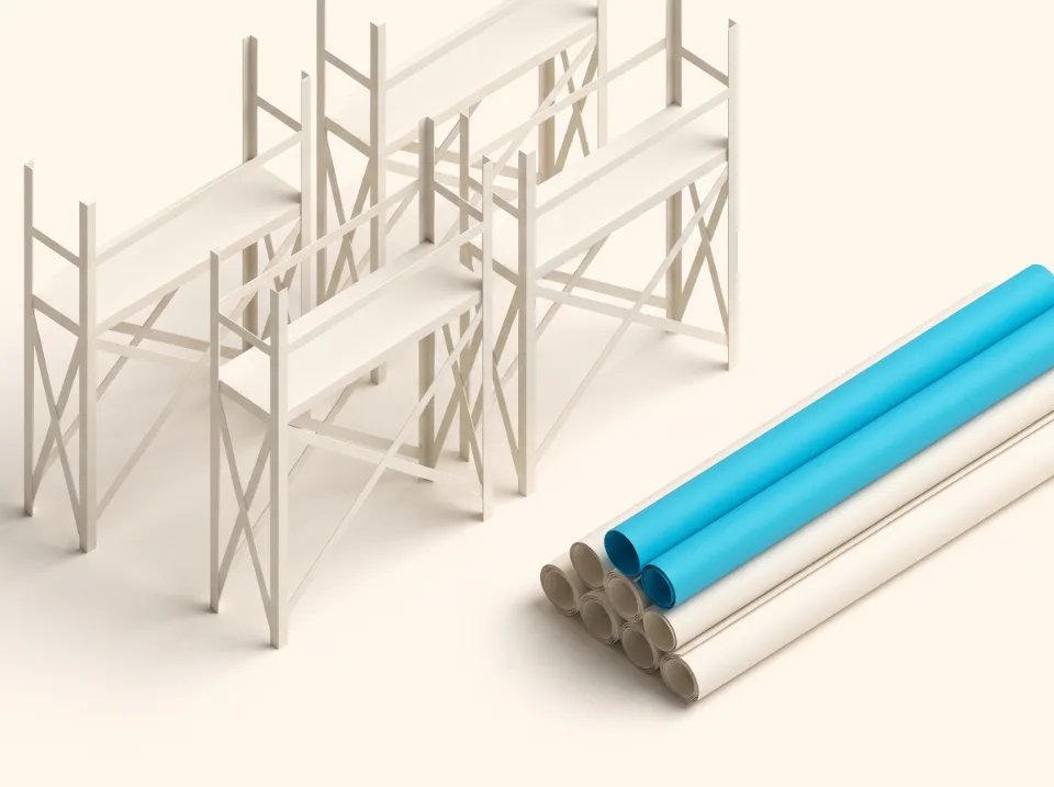 Papier-Illustration: Gerüstrahmen aus Faltpapier neben einem Stapel Planrollen – Sinnbild für Bau und Ausbau in Schwalmtal, eine Rolle in Cyan